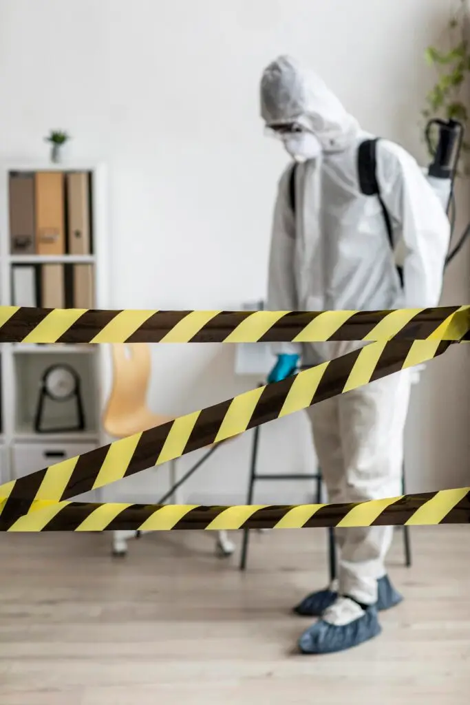 person disinfecting restricted area